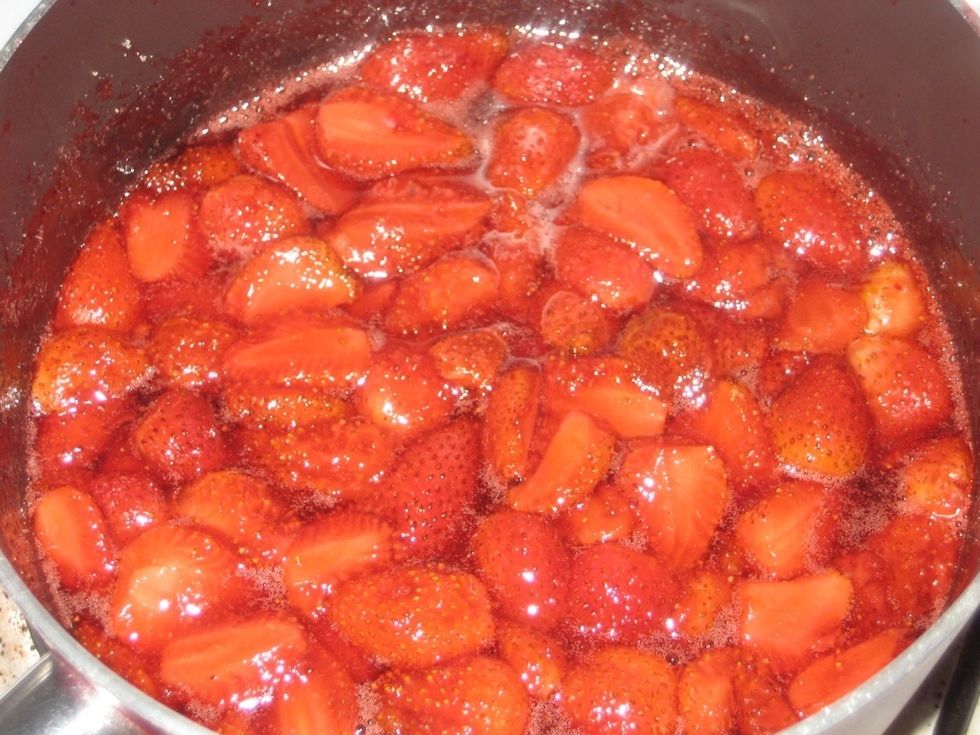 Stir over low heat till it dissolves then increase heat to allow to boil. Make sure it's fully dissolved before boiling to avoid a grainy jam. When stirring check the back of the spoon has no granules