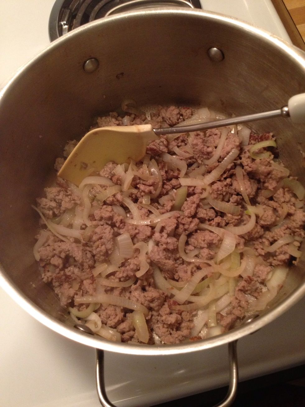 Stir sausage and onions occasionally until cooked through. If using Italian sausage, you may want to drain it before continuing to the next step.