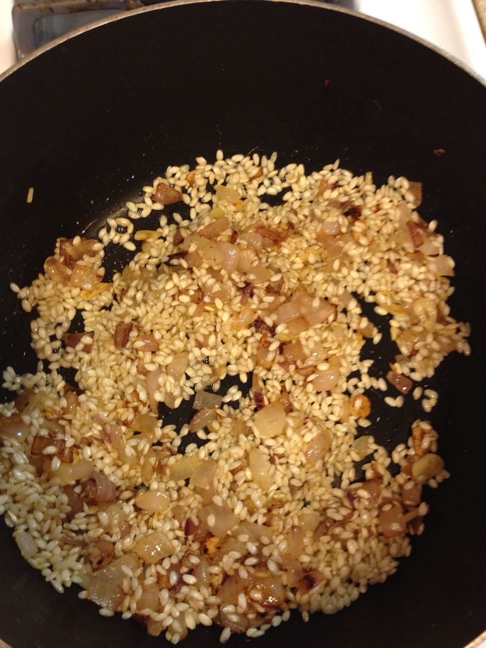 Stir so that the arborio is coated in the butter.
