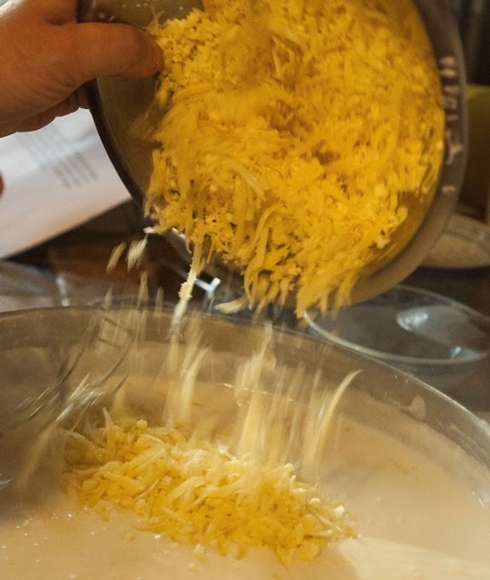 Stir the cheese into the thickened roux along with the salt and pepper.