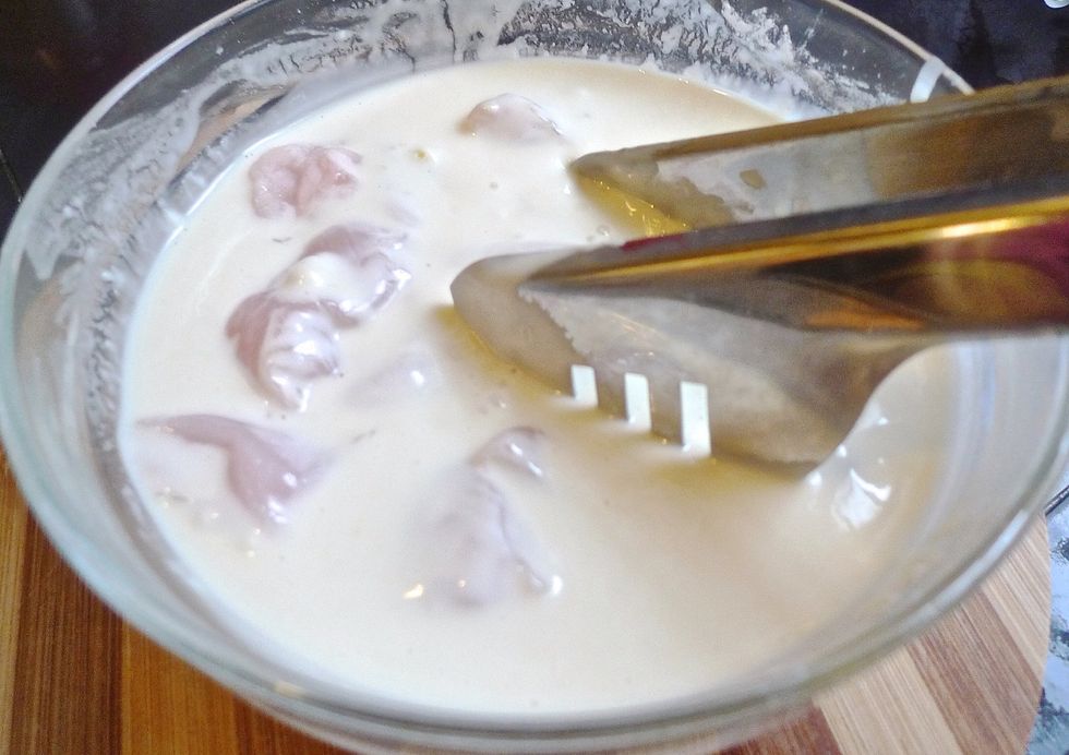 Stir the chicken in the batter until it is well coated.