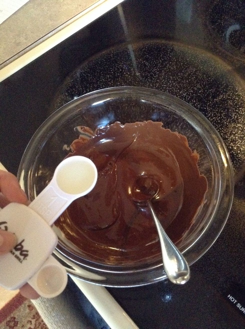 Stir the chocolate to remove any extra lumps. Then add 1 teaspoon of vegetable oil and stir.