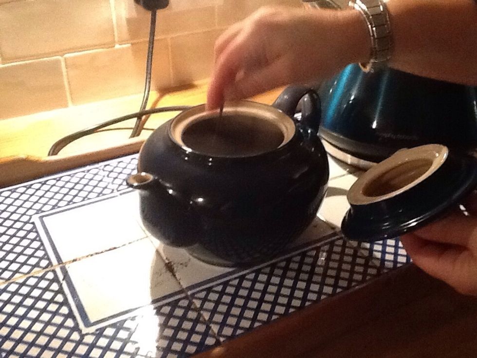 Stir the hot water and tea bags together.