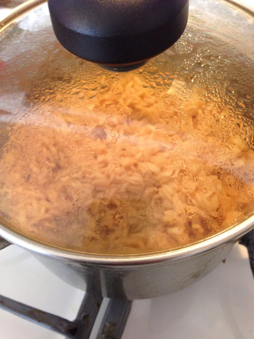 Stir the rice once to make sure all liquids have been absorbed and the rice isn't burning.