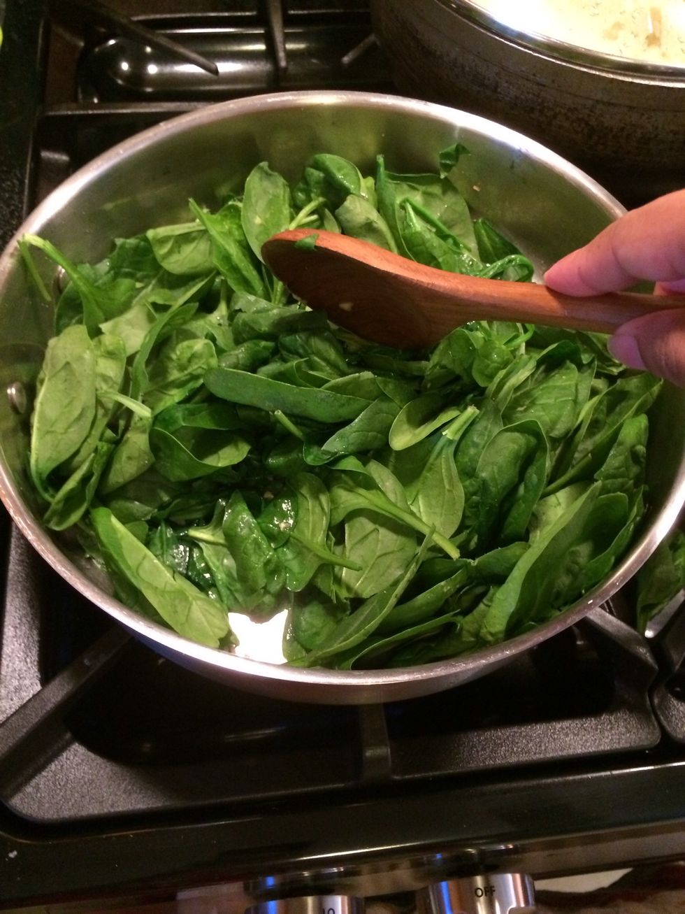 Stir the spinach. You will see it is starting to wilt
