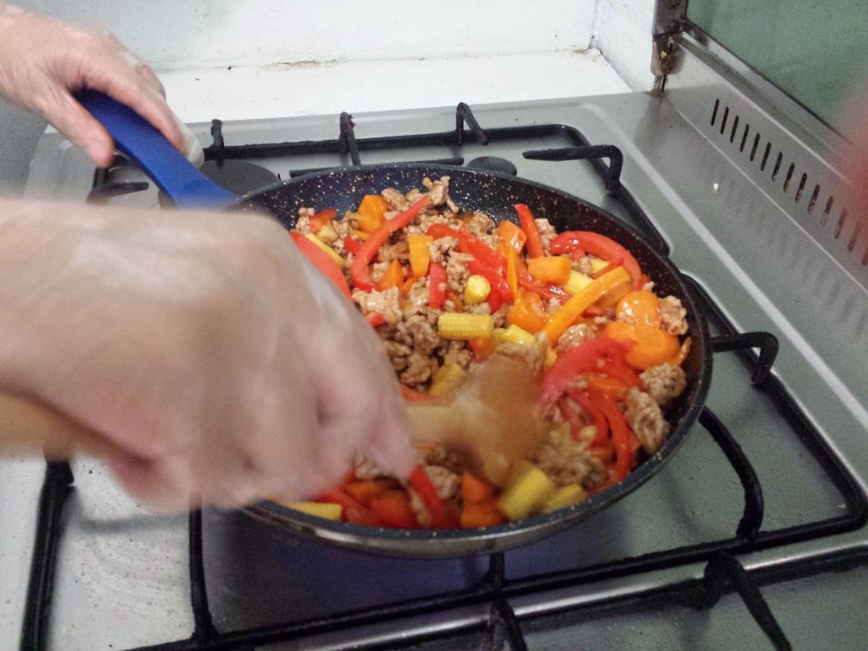 Stir the veggies through the meat.
