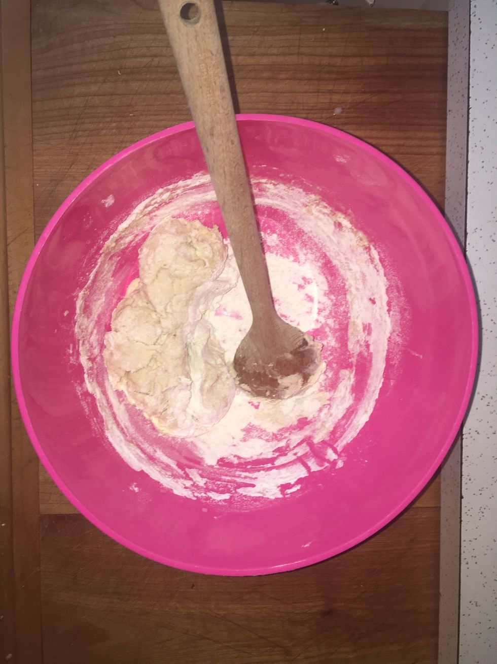 Stir the yeast mixture into about 2 cups of flower until the dough follows your spoon