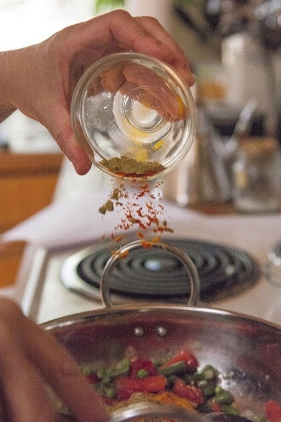 Stir them around and add in the turmeric, Kashmiri chili, salt, garam masala and ground coriander. Simmer everything together for 15 minutes. Its done when the tomatoes have softened and turned pulpy.