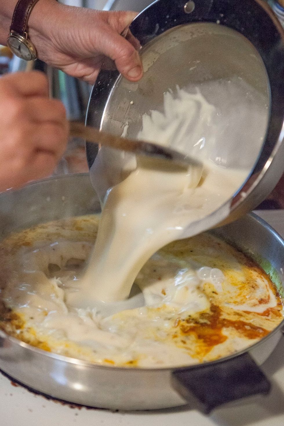 Stir them around for a moment or two then add in the yogurt, besan, water mixture.