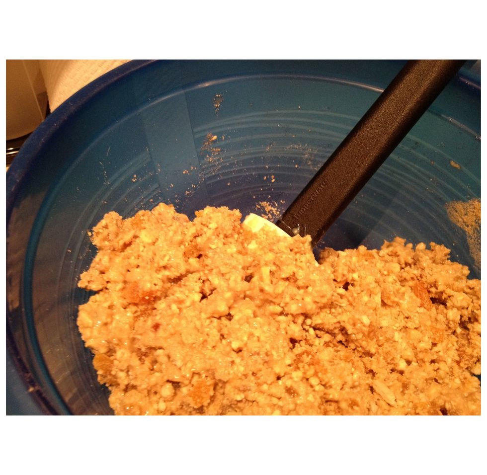 Stir through the condensed milk. You need to be quick here, because as soon as the condensed milk mixes with the biscuit crumbs & apricot pieces, it starts to set. Once mixed, use hands to roll balls