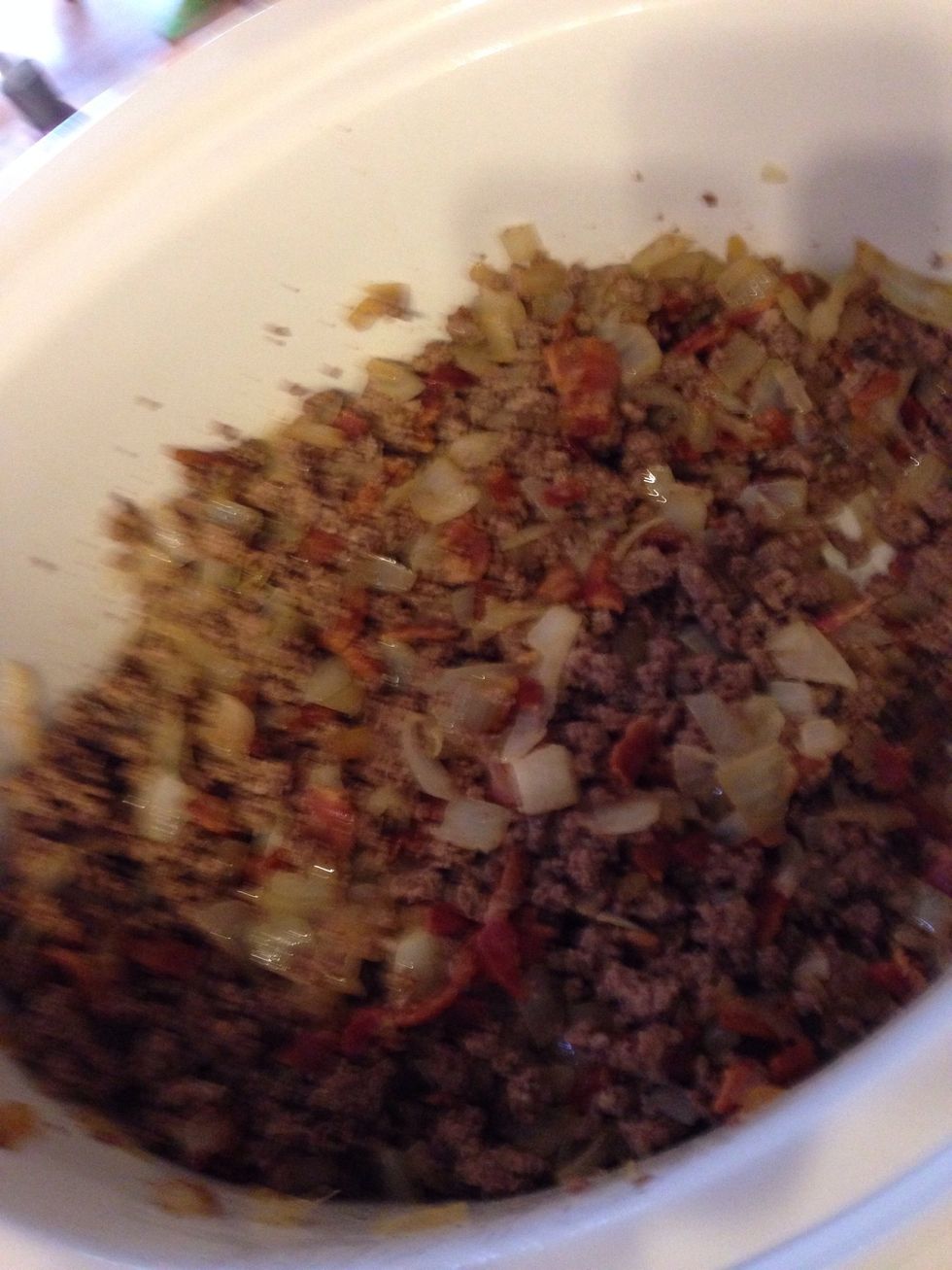 Stir to combine beef, bacon, and onions.