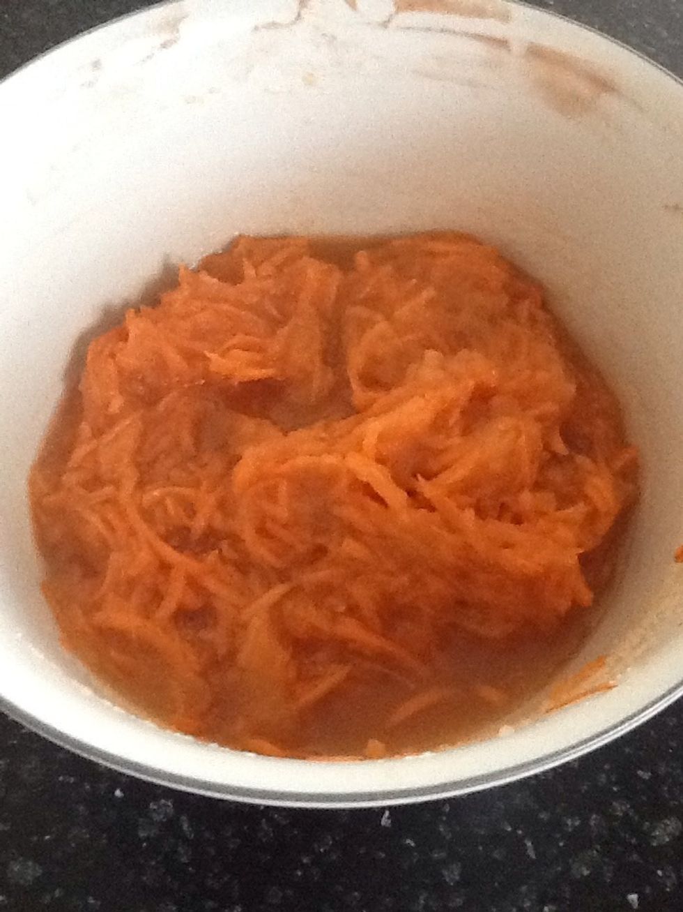 Stir together carrots, orange zest, honey, applesauce, 1 teaspoon vanilla, and walnuts, if using.