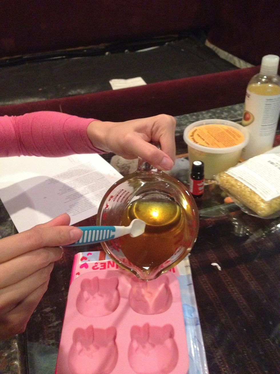 Stir well. Add your favorite essential oil. Place mold on a book. Pour mixture oil in the mold.