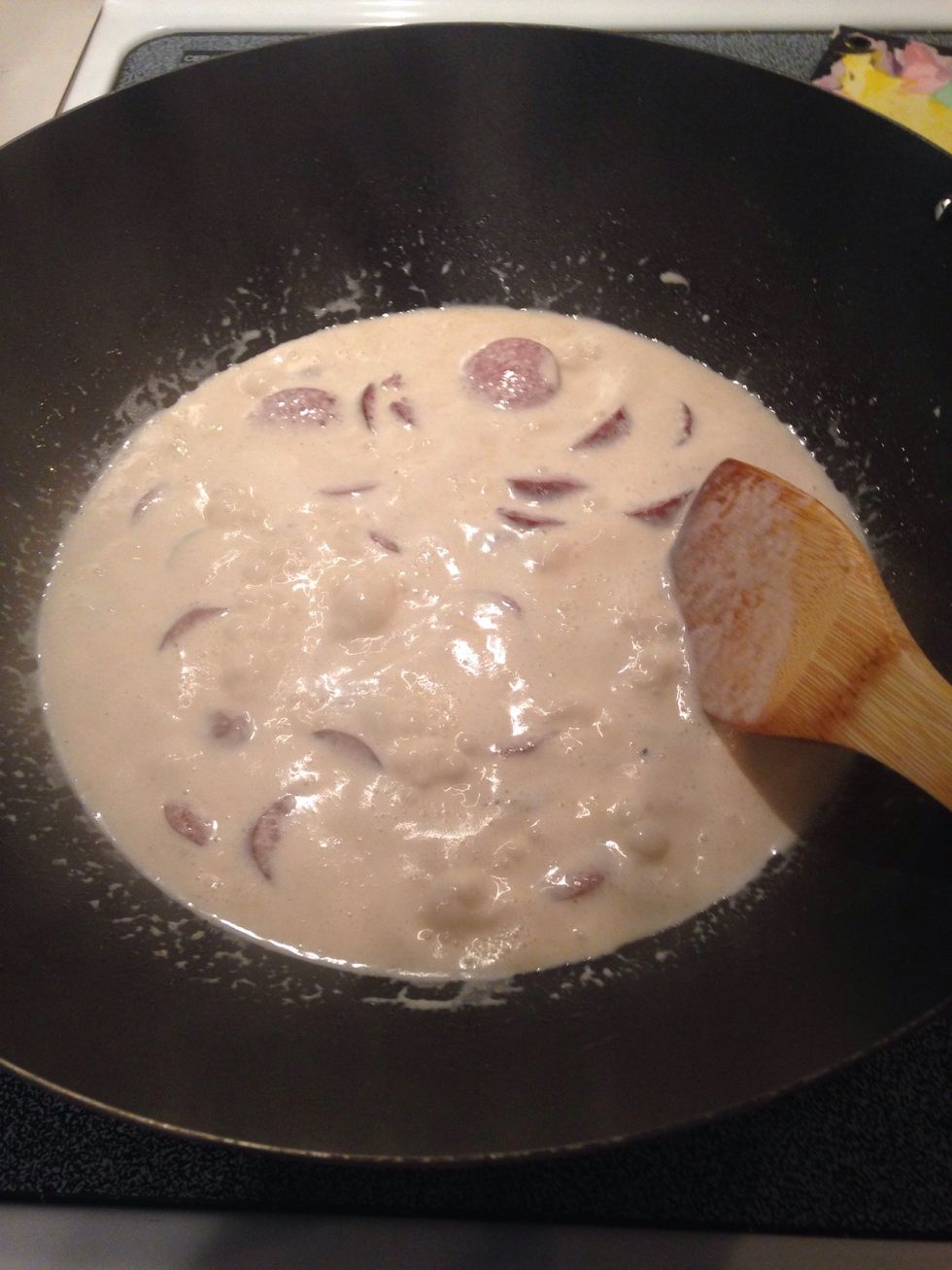Stir. When cream starts to boil, reduce heat and stir non-stop.