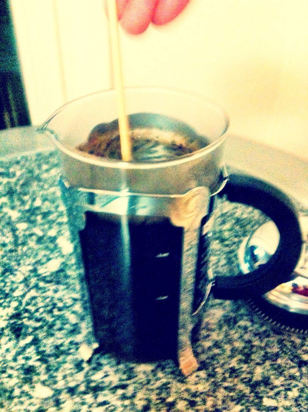 Stir with a wooden spoon or a stick! (a metal spoon might chip or crack your precious coffee maker!)