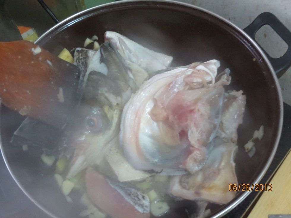 Stirfry garlic, leek, and ginger, then toss in fish