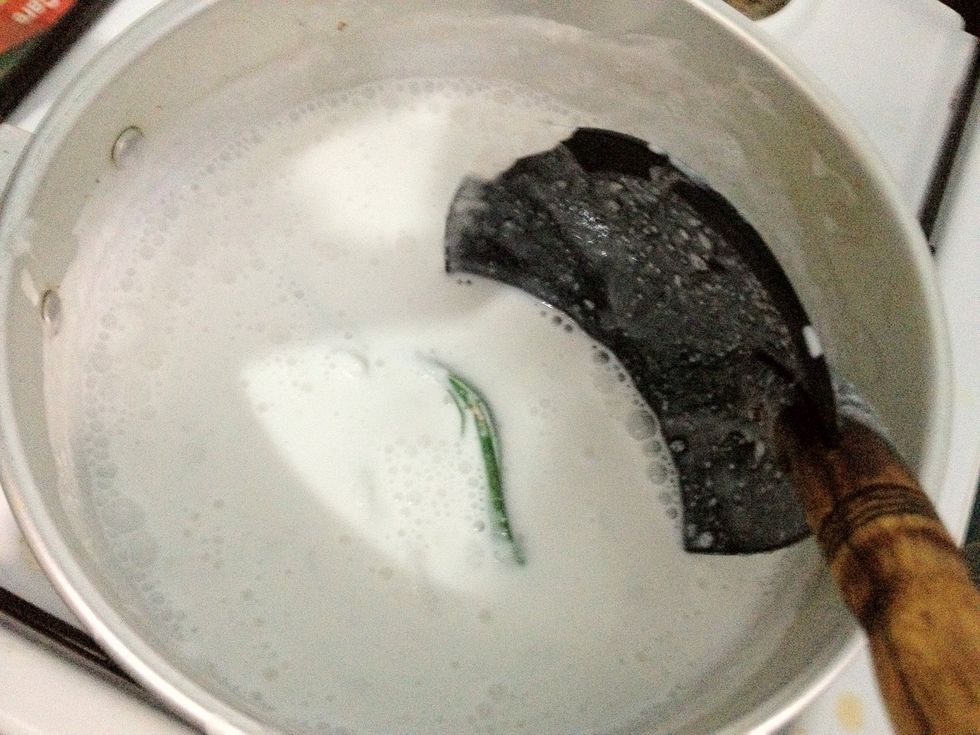 Stirring constantly so the coconut milk won't break