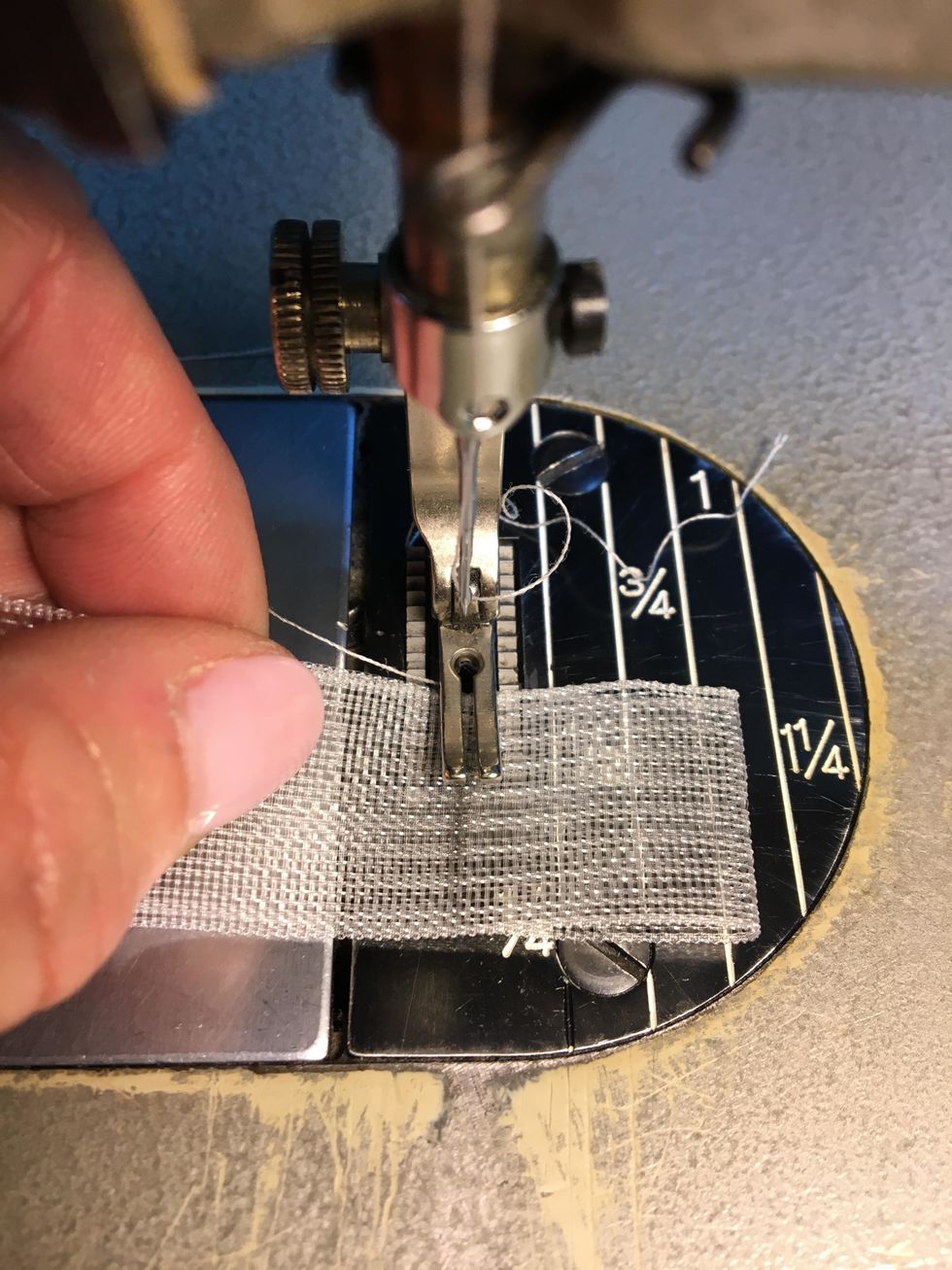 Stitch across the tape along the pencil lines creating the 1" tab. Repeat until your strips have all the tabs sewn in.