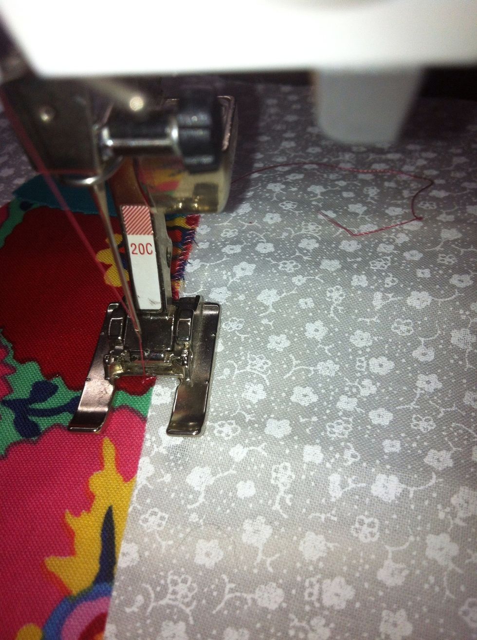 Stitch along following edge of the appliqu\u00e9 so the needle swings from the Background fabric at the edge of the appliqu\u00e9 into the Appliqu\u00e9 itself. Finish with a few stitches at 0 length to tie off.