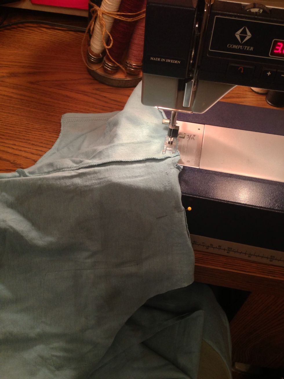 Stitch around the trimmed sleeve to the centered curve.
