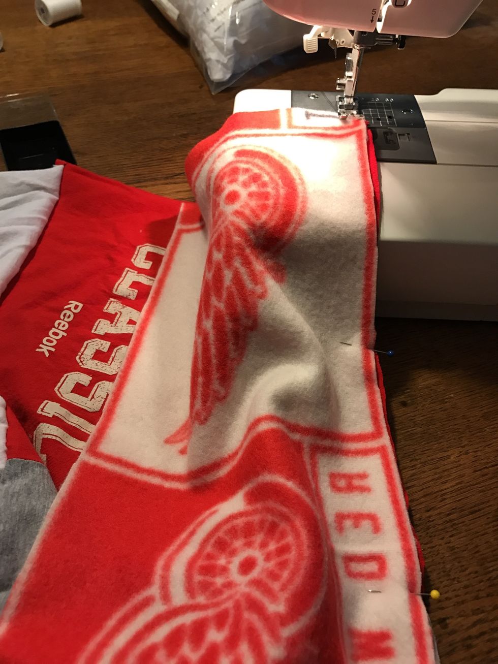 Stitch fleece to blanket at 3/8" (keep the right side of the fabric lined up with the right side of the pressed foot) and backstitch at the top and bottom of the seam.