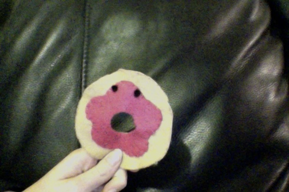 Stitch the eyes onto the doughnut front with black thread. (I used a cross stitch).