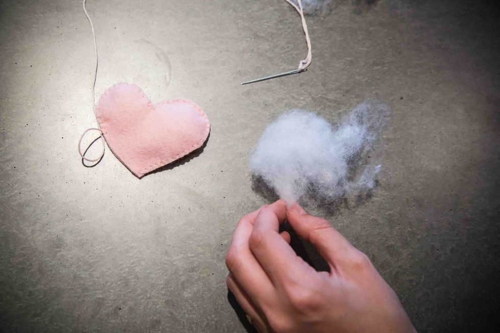 Stitch the heart until you are left with roughly 2-fingers width left unstitched. Take out your stuffing and pull off a small handful.