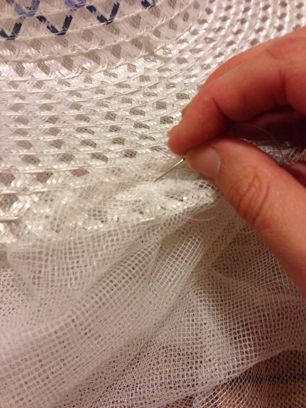 Stitch the tulle onto the brim of the hat to hold it in place. If you want, you could staple it on - I won't tell anyone ;)