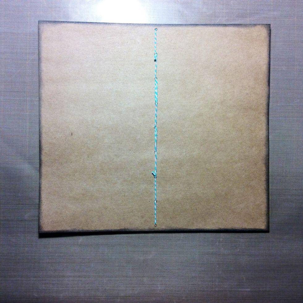 Stitch through holes with coordinating thread to hatch pages to cover. I used bakers twine. Fold memo book in half so stitching goes down the spine.
