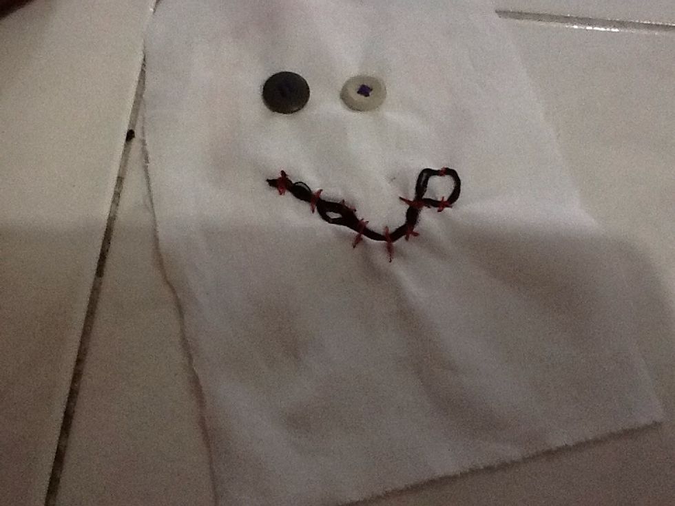 Stitch your folded string onto the fabric any way u desire , in a smile , frown or angry , u can add eyebrows if u want to as well