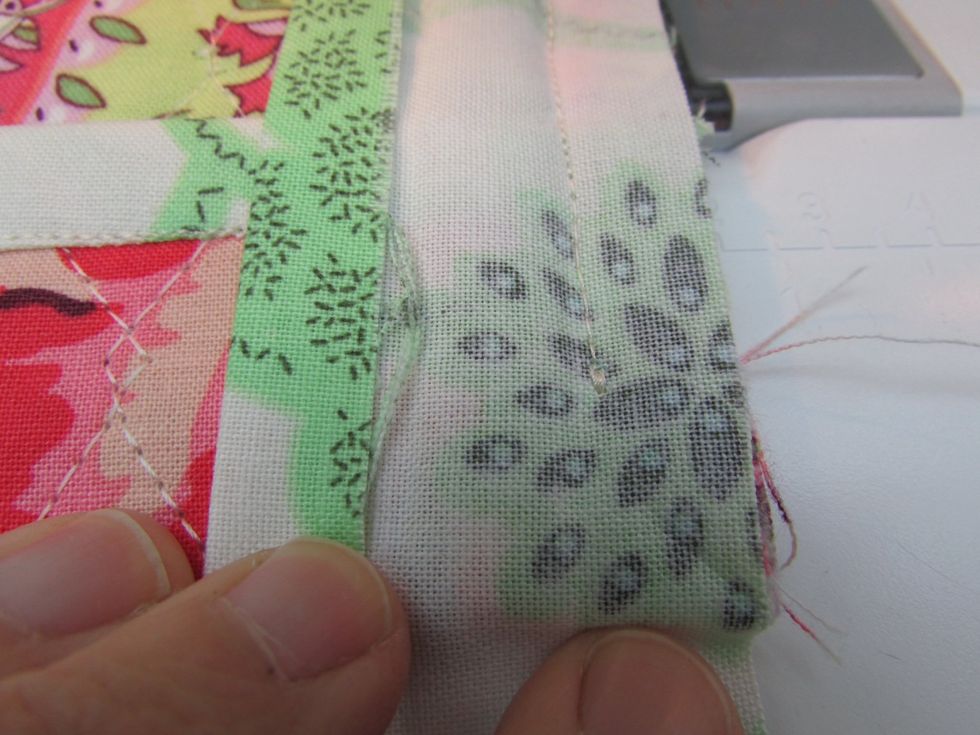 Stop and secure stitching 1/2" before the corner. This is how I make a sharp corner: