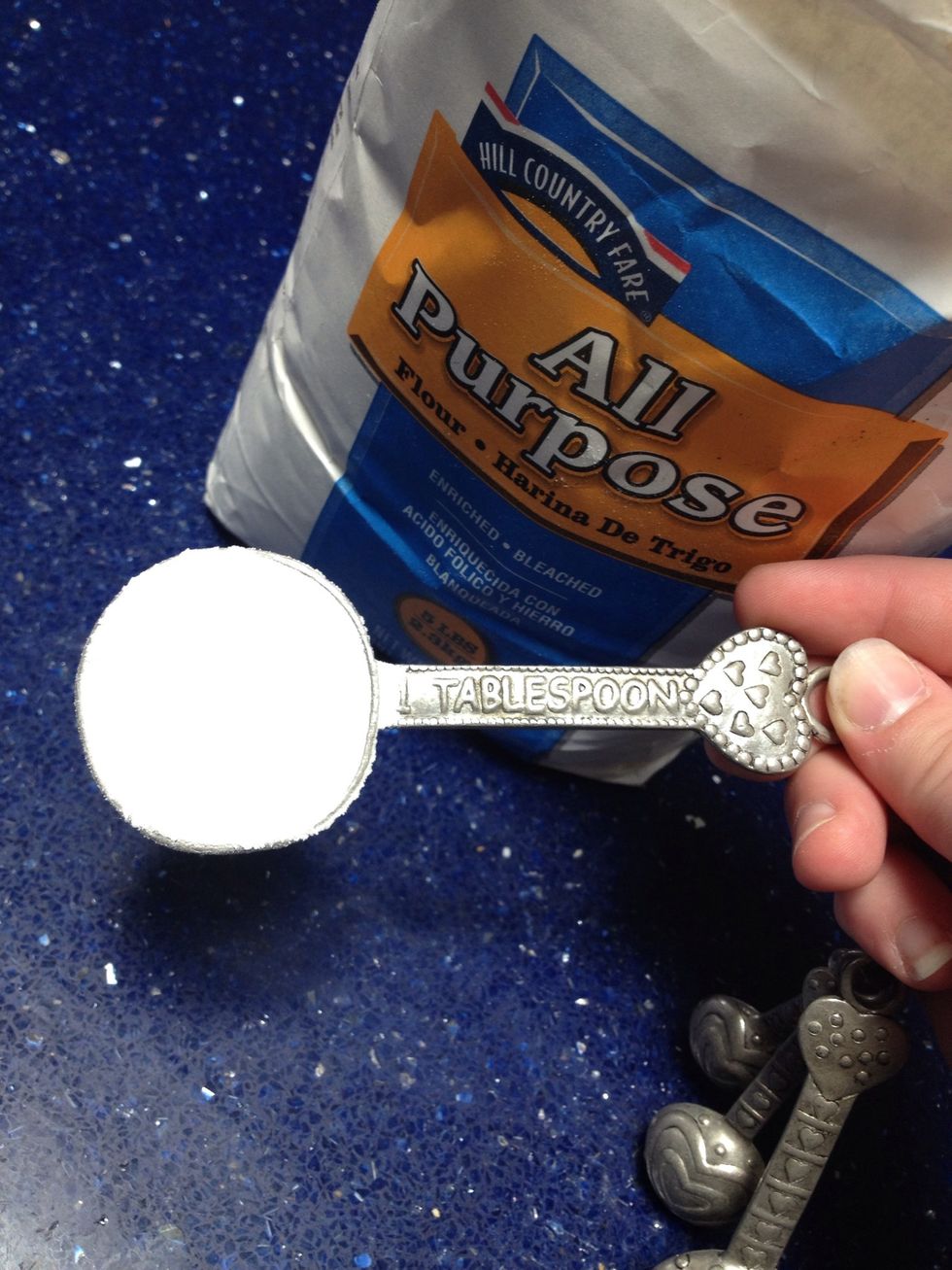 Stop the mixer and measure two tablespoons of flour