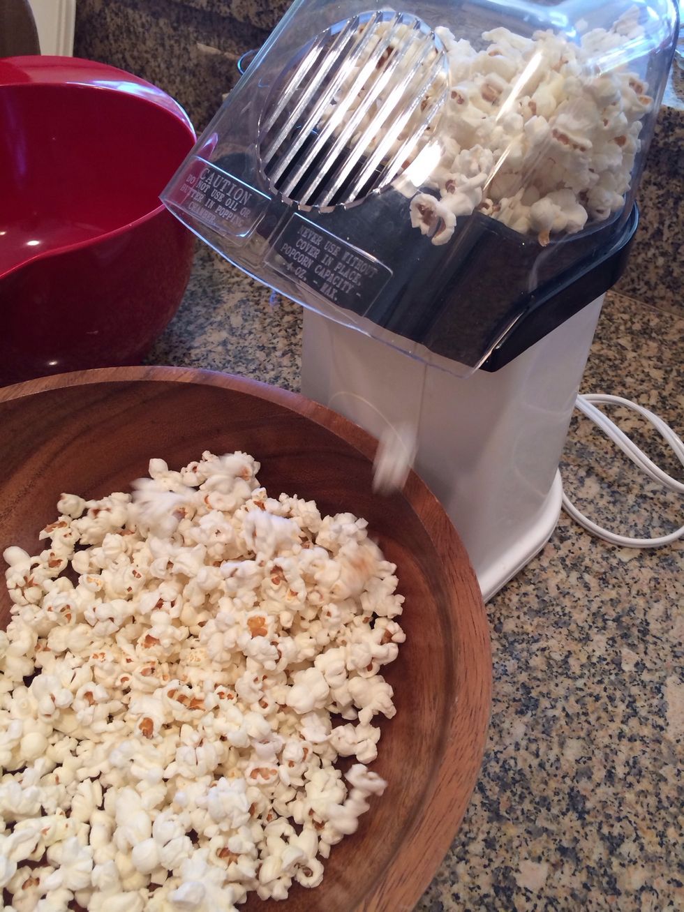 Stop when you don't hear any popping kernels for about 5 seconds in a row. Don't wait until it's empty.