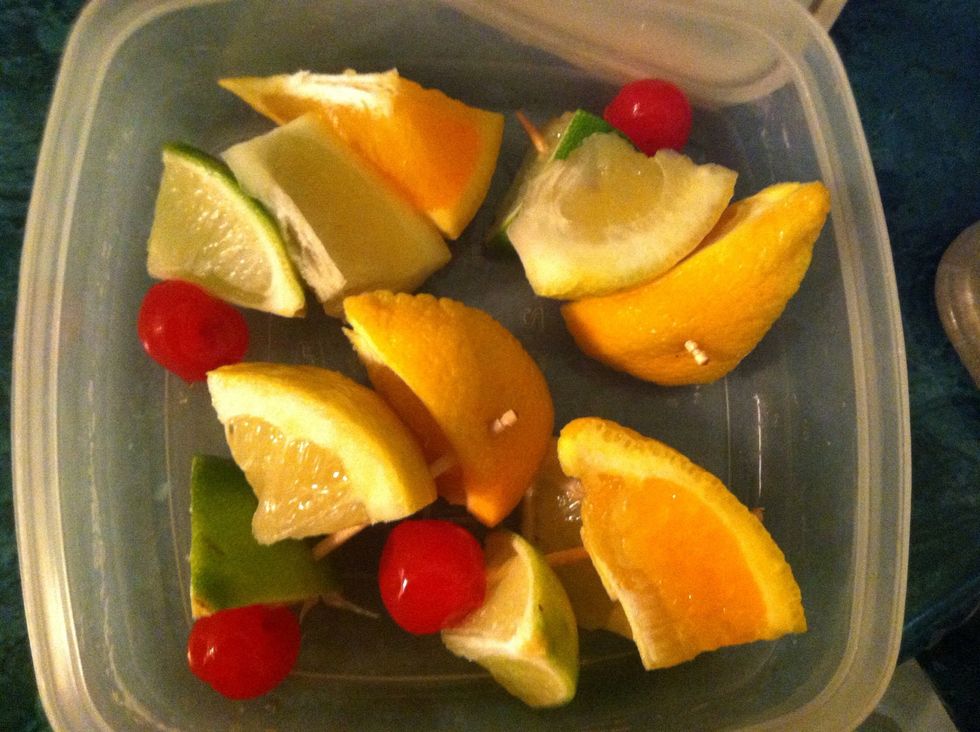 Store your garnishes in a small tupperware container in the fridge while the Sangria chills and marinades