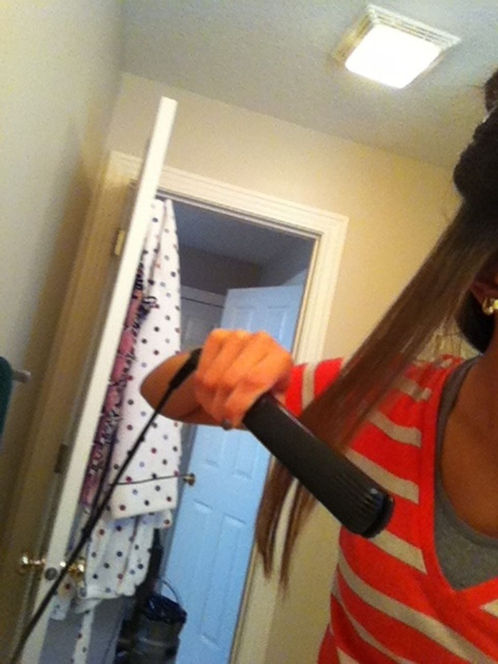 Straighten the piece of hair so your hair is hot (this helps it curl better)