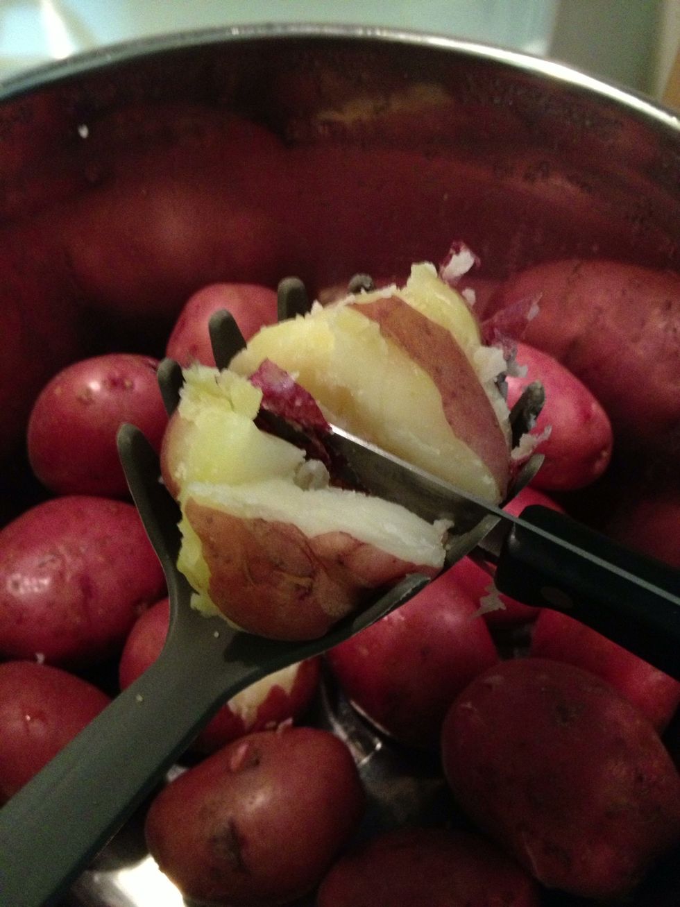 Strain and slice the potatoes. I like to use a slotted spoon to hold the potatoes as I slice them. I use the spoon as a guide and make two vertical and three horizontal cuts. Like a mitre box.