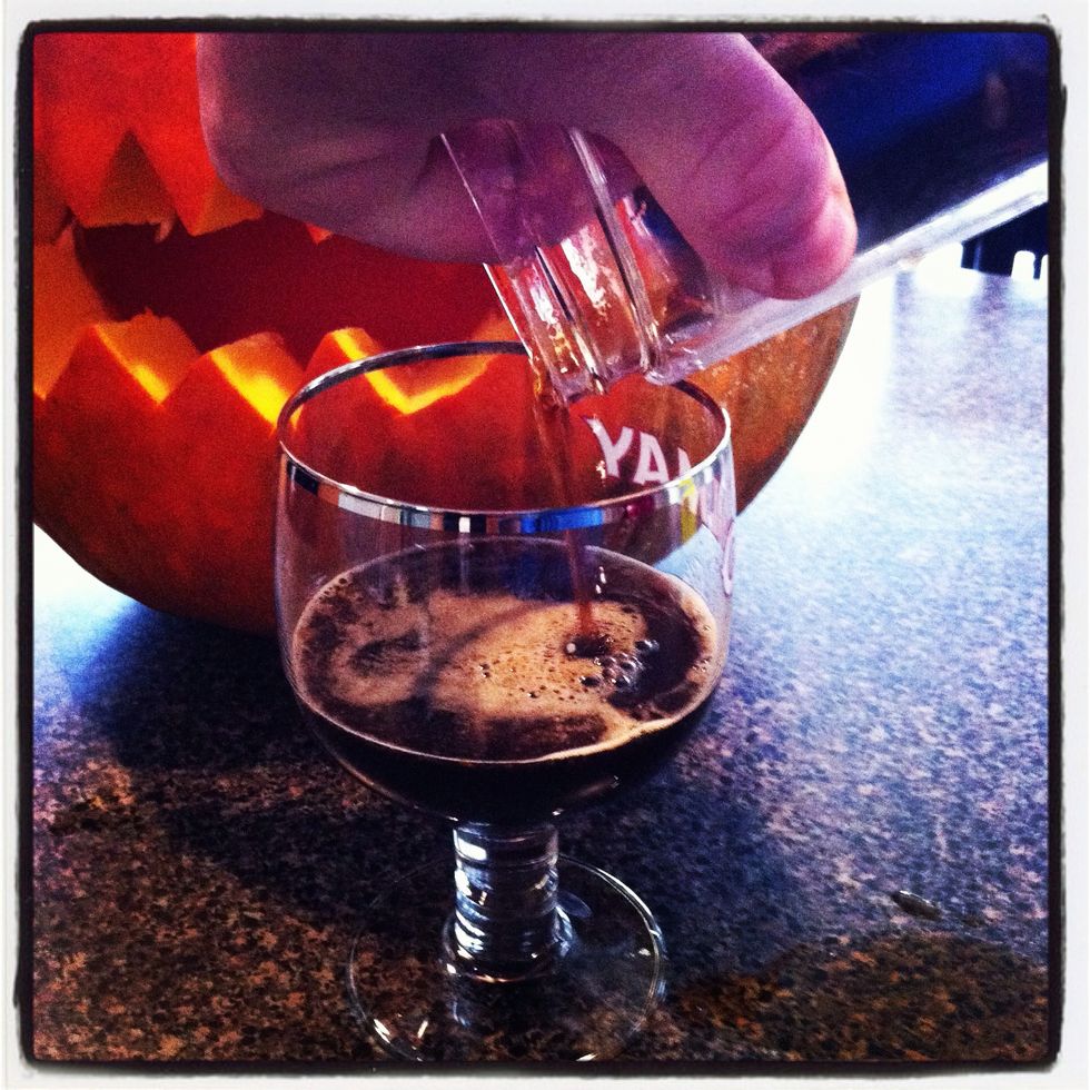 Strain beer into glass.