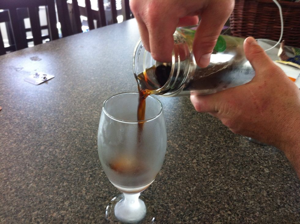 Strain beer into glass.