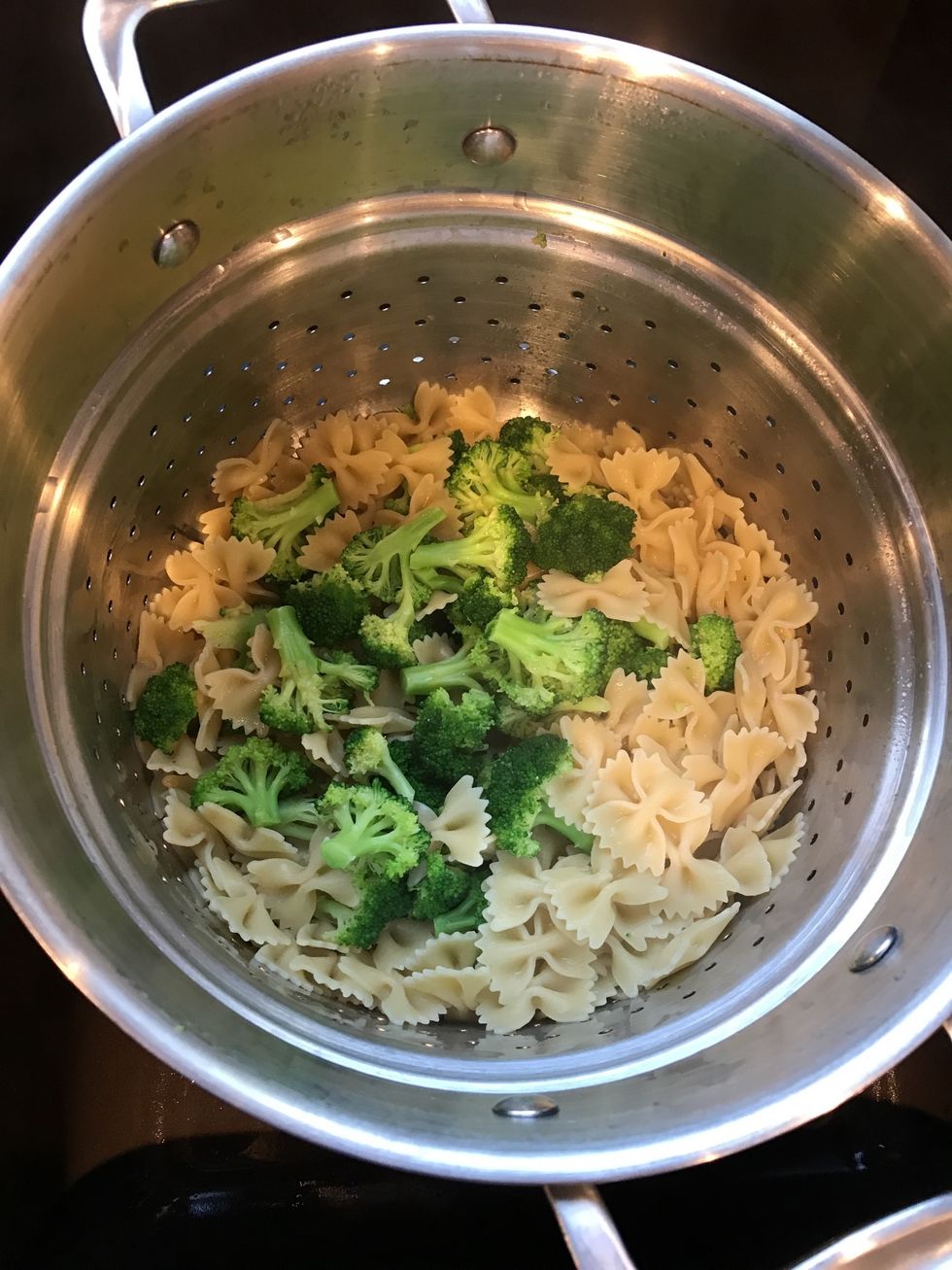 Strain cooked pasta and broccoli, set aside