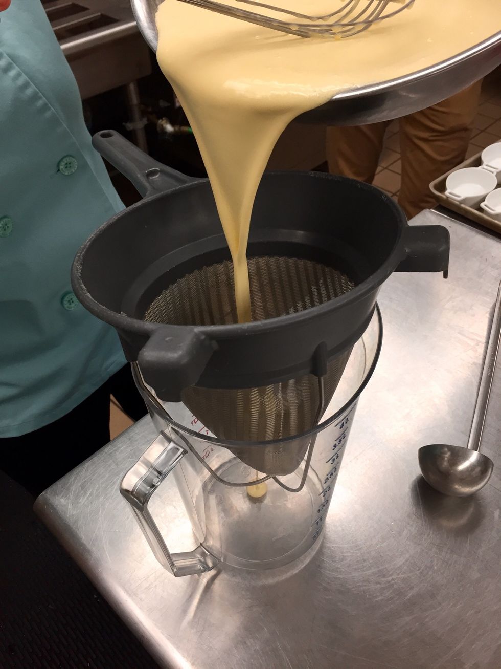Strain creme brulee batter into a pitcher.