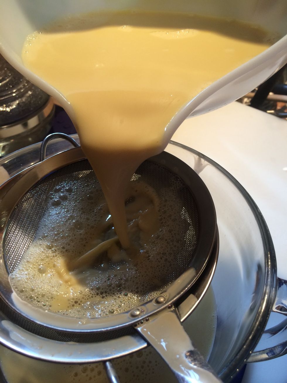Strain custard before pouring into dishes, this removes any pieces of egg that might not have been dissolved by whisking. This step also helps make the custard velvety smooth.