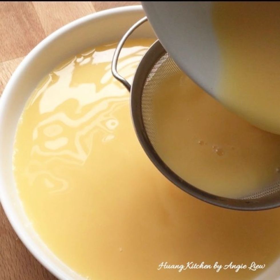 Strain egg mixture into a shallow heatproof bowl.