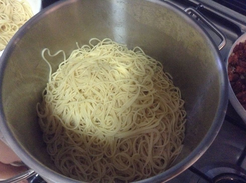 Strain in cold water to stop the cooking of the pasta