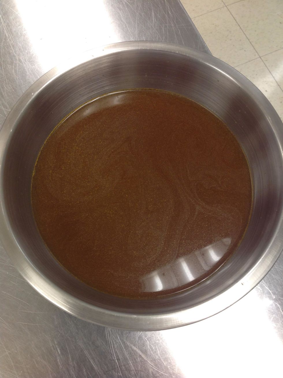 Strain ingredients with towel to catch all of the broth in a bowl.