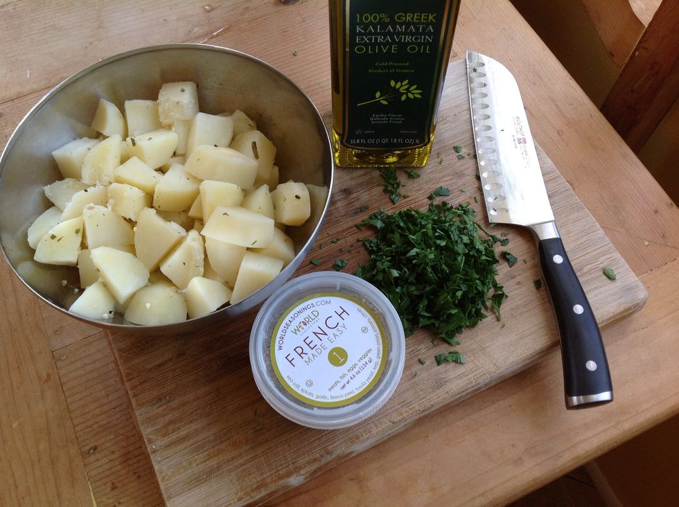 Strain potatoes, place in bowl and let them cool a bit. Add the olive oil, parsley and remaining 3/4 teaspoon of #1French Made Easy.