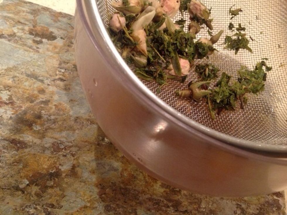 Strain the herbs from the tea using a strainer or cheesecloth.