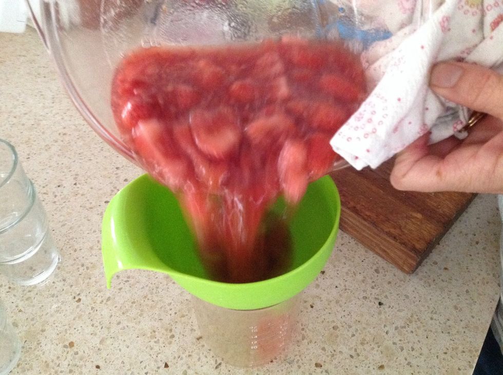 Strain the jelly through a sieve into a glass or jug, reserving the strawberries aside.