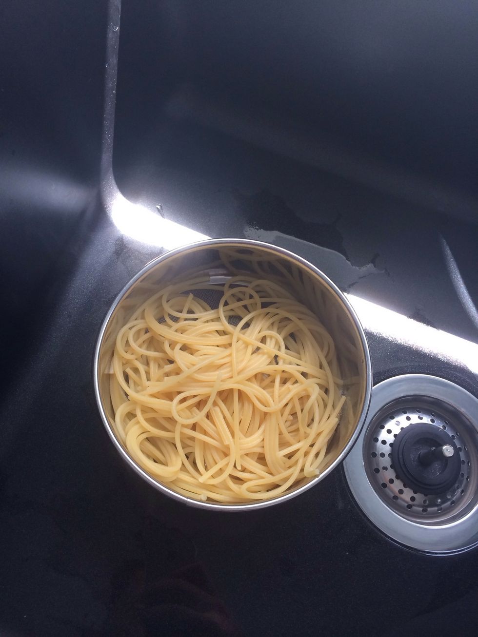 Strain the pasta once it is cooked and put aside.