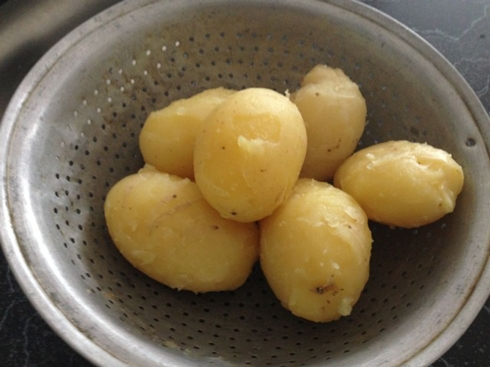 Strain the potatoes into a large strainer and let it sit for a whole before peeling. Peel potatoes with hand