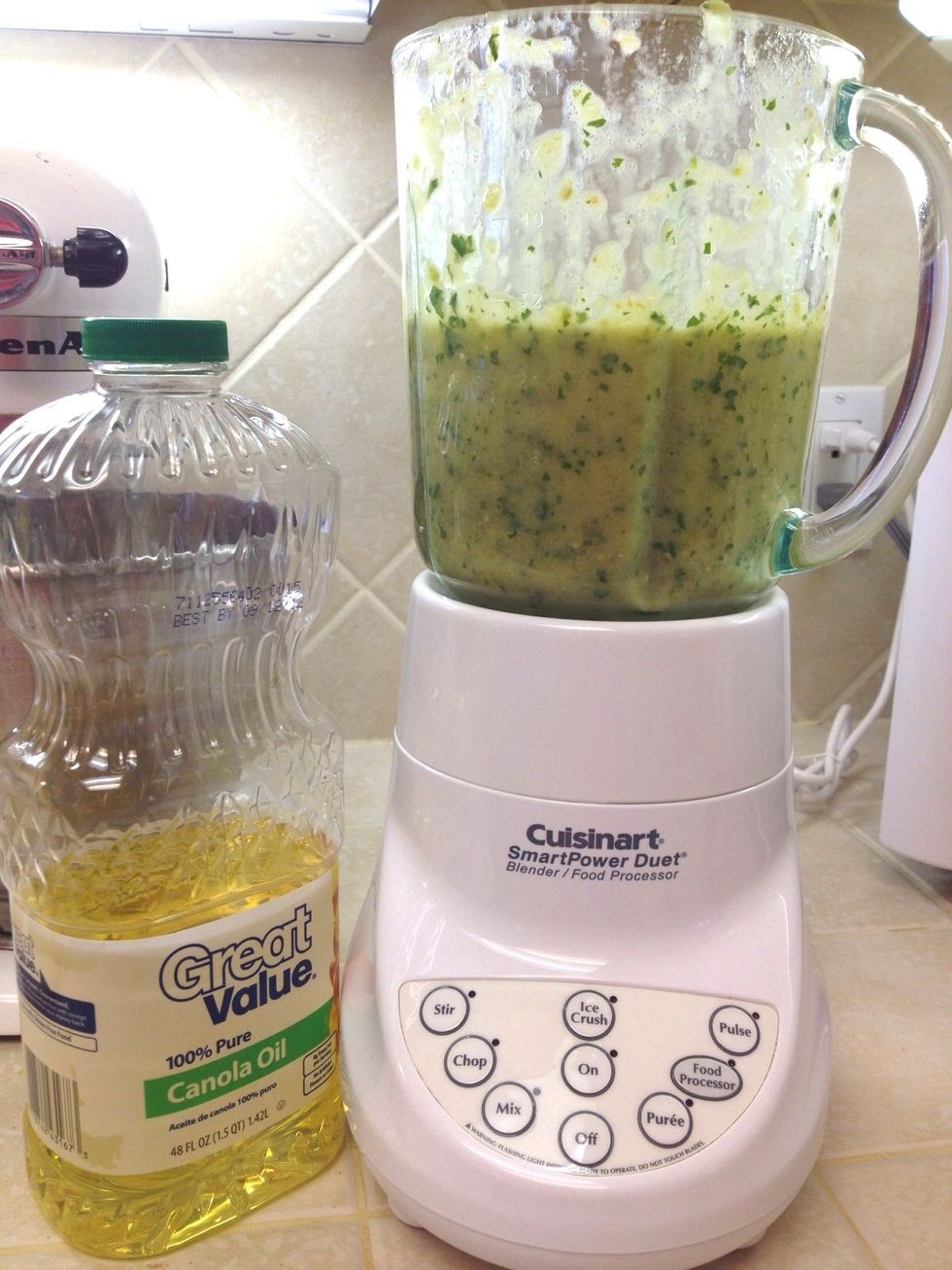 Strain the tomatillos, onions and jalape\u00f1os. Add to blender with 2 Tbs cooking oil, cilantro, chicken cubes and lemon juice. Blend until only slightly chunky (as seen in this photo).